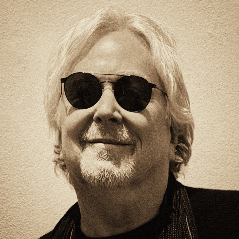 Portrait of Glen Wexler, black-and-white, wearing dark sunglasses.